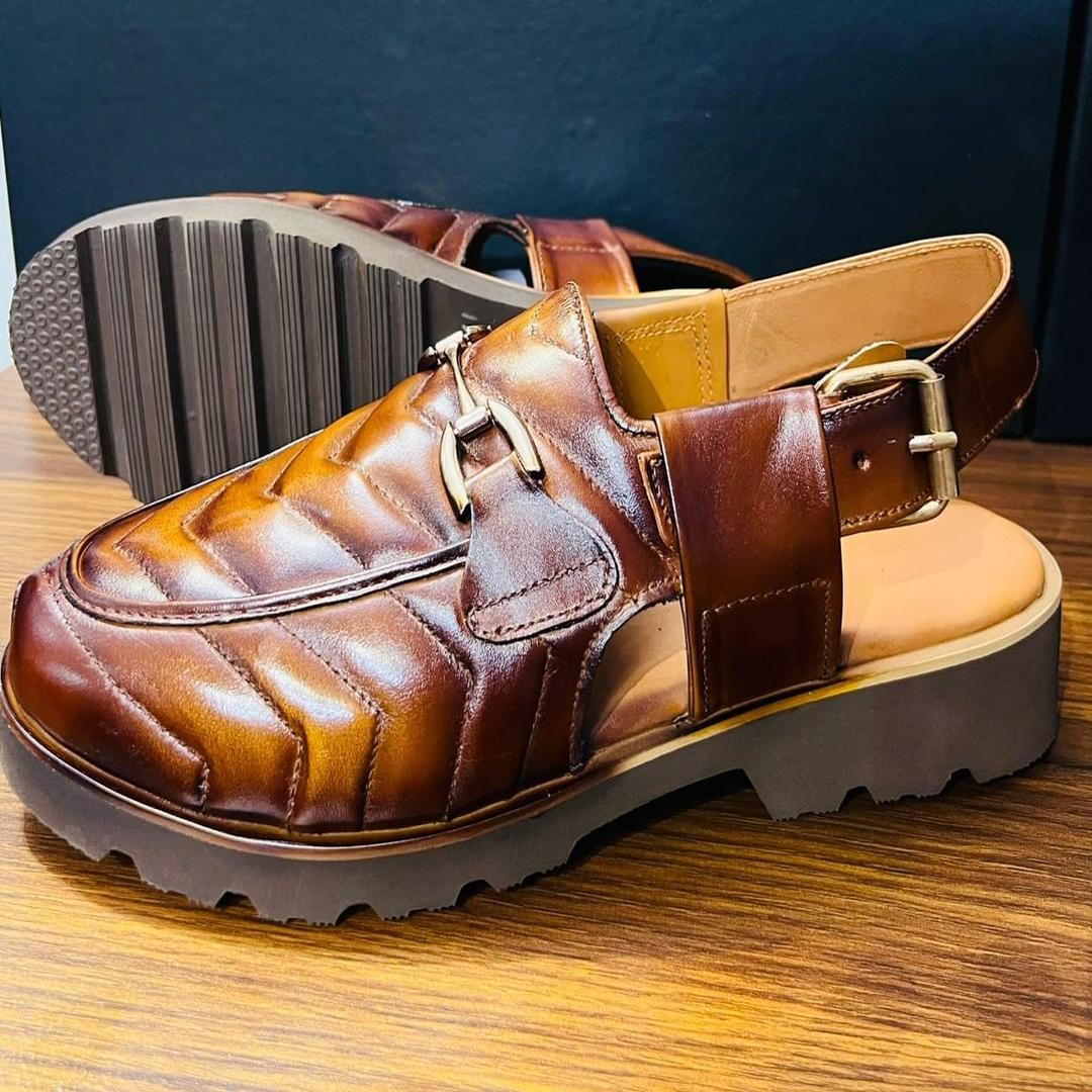 A stylish brown leather sandal with a quilted design on the front,